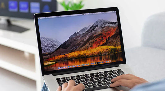 Customer checking MacBook Pro before purchase at PayMore Springfield