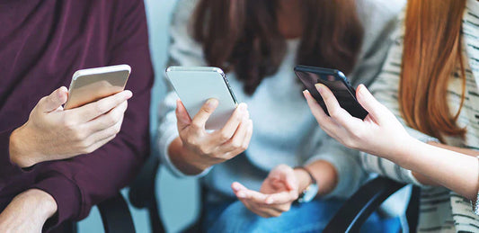 Customer reviewing Android smartphones before purchasing at PayMore Springfield