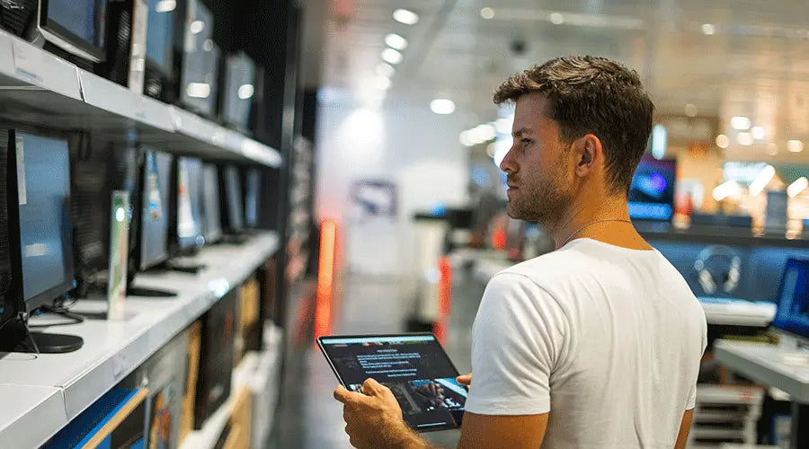 PayMore Springfield technician examining a pre-owned laptop