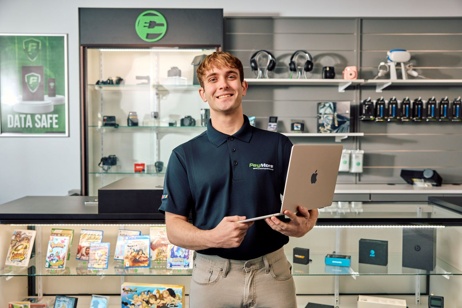 paymore employee holding a laptop and smiling